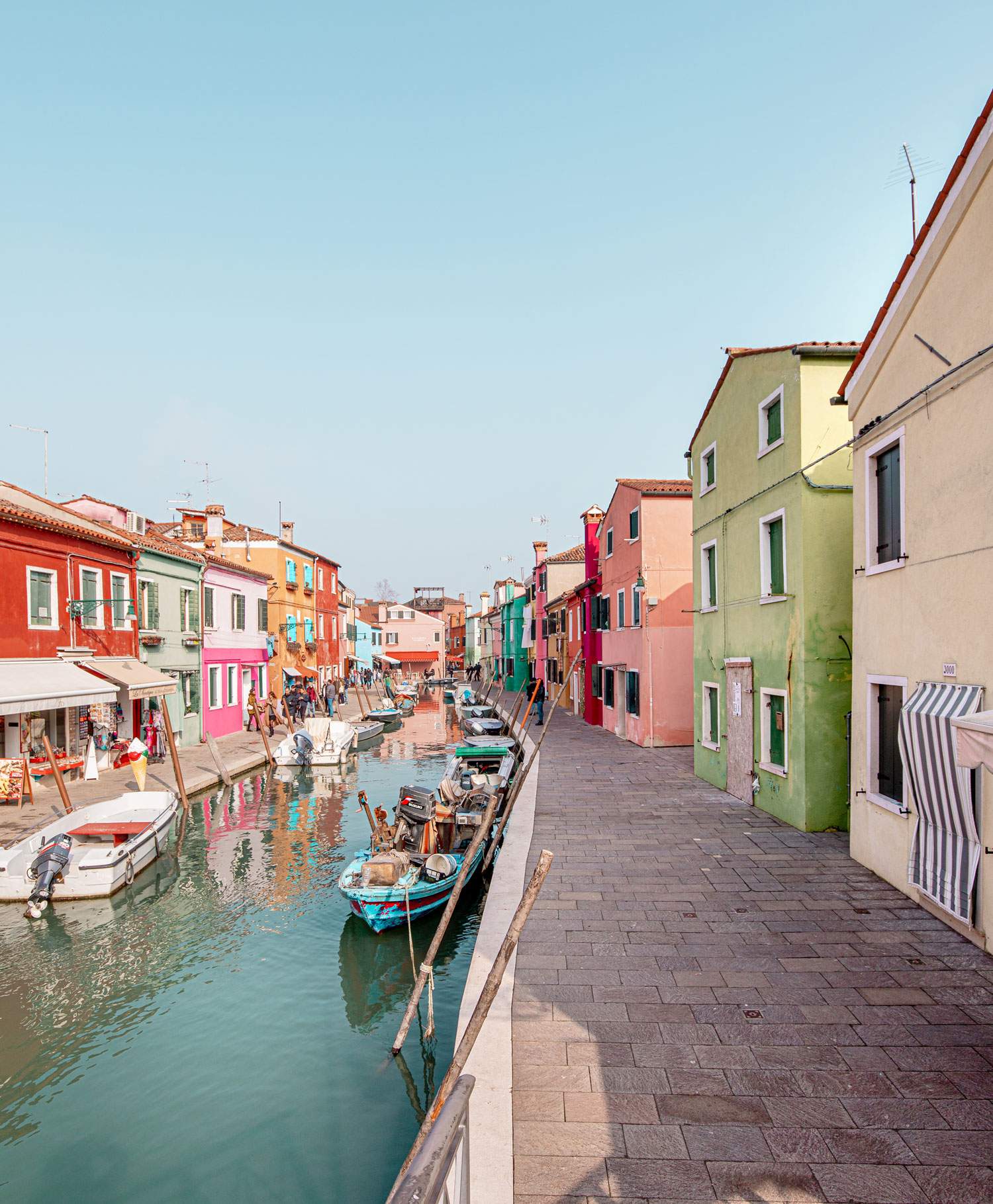 canal in Burano lined with rainbow coloured houses