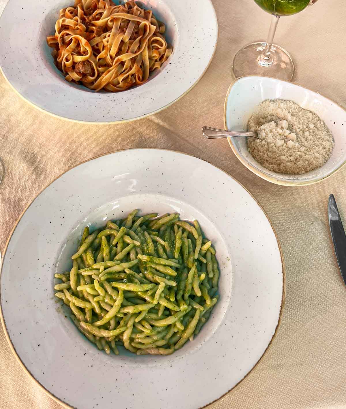 bowl of pasta with green pesto sauce