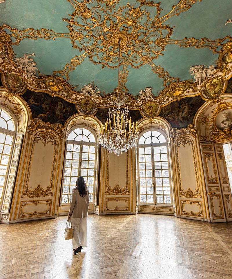 grand room with decorative ceiling and big chandelier