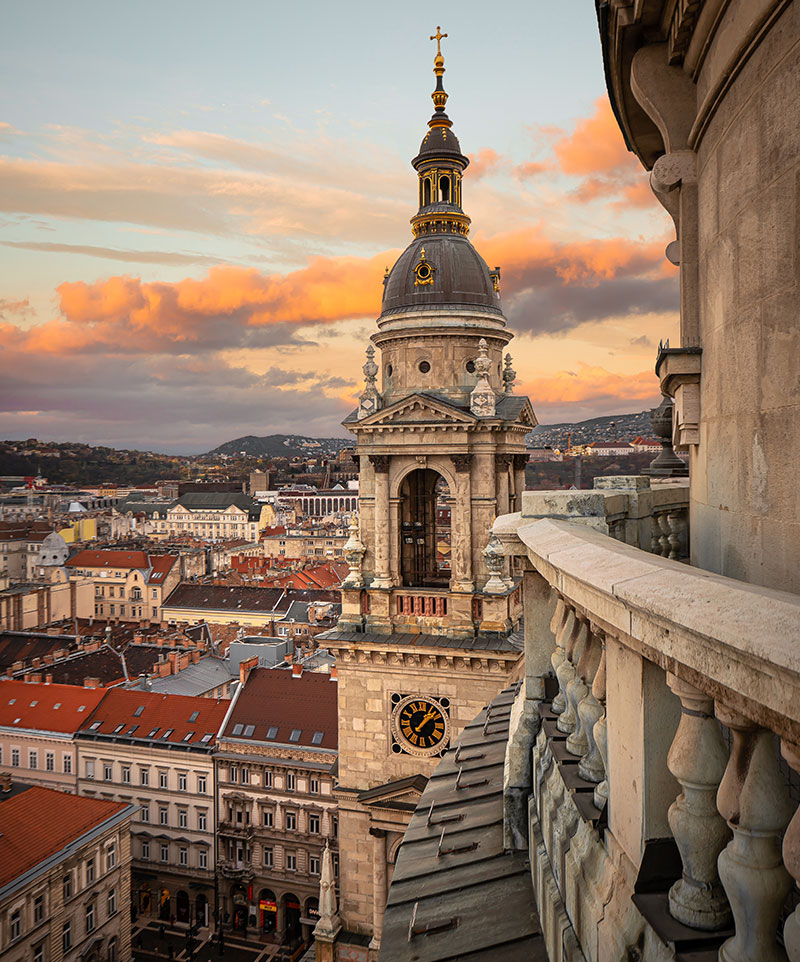 Sunset sky behind tower rooftop on top of St. Stephen's Basilica​