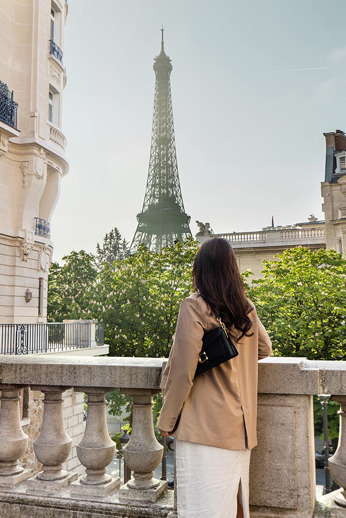 woman standing in front of eiffel tower
