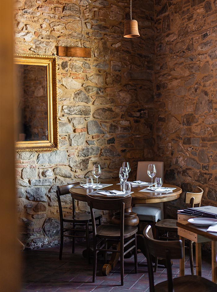 authentic tuscan restaurant dining room with brick walls and wood table and chairs