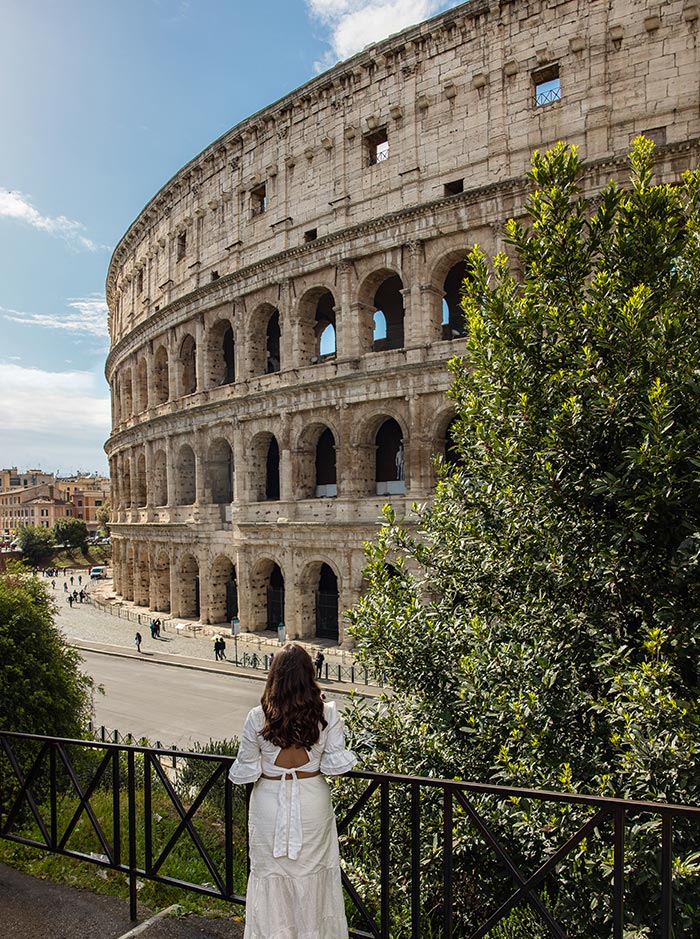 woman standing in front of Colosseum